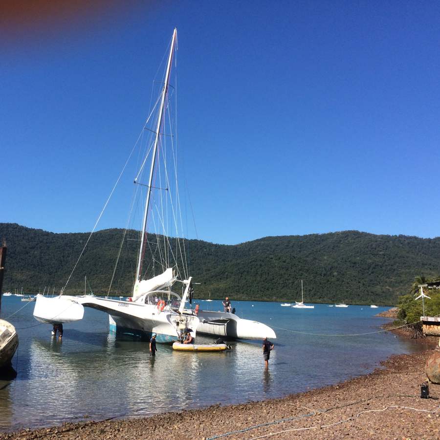 Boat beached for hull cleaning at low tide in the Whitsundays